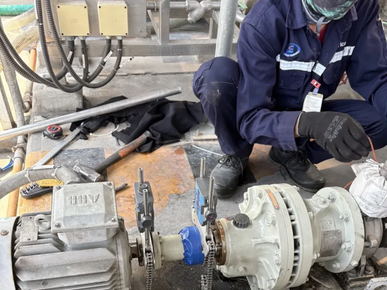 Plant Equipment engineer aligning a pump and motor on site with a laser alignment tool