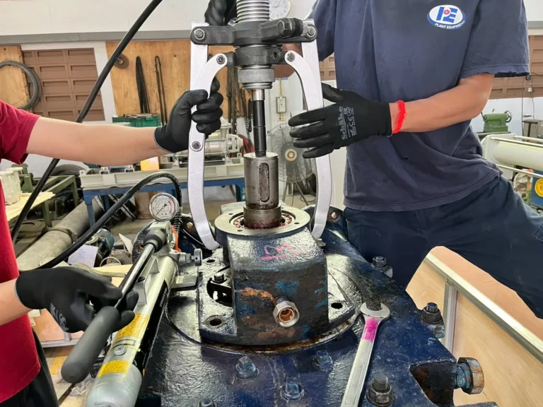 Plant Equipment technicians overhauling a vacuum pump in the workshop